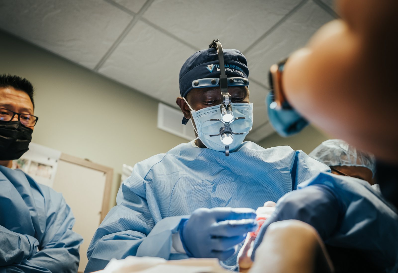 Dr. Charles performing implant surgery in the dedicated operating room